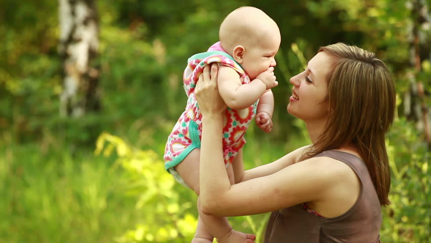 Mother playing with a newborn baby