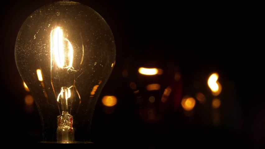 A light bulb illuminates a dark room, much like an idea in our mind.