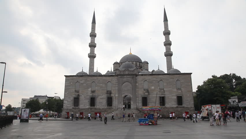 ISTANBUL TURKEY - JULY 30: Visitors outside the Yeni Cami Mosque in Istanbul July 30 2011. The Yeni Camii Mosque  is an Ottoman imperial mosque located in the Eminu district of Istanbul, Turkey. 