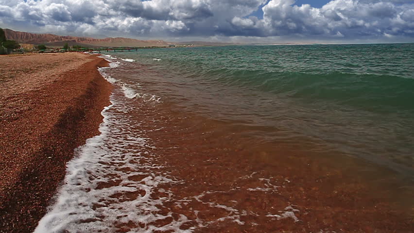 Bright terracotta sand and clear water