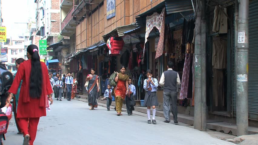 KATHMANDU - CIRCA 2010: People, cars and bikes circulate through the city circa 2010 in Kathmandu.