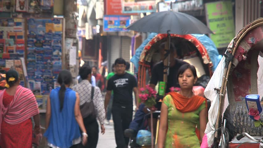 KATHMANDU - CIRCA 2010: People, cars and bikes circulate through the city circa 2010 in Kathmandu.
