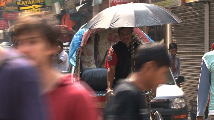 KATHMANDU - CIRCA 2010: People, cars and bikes circulate through the city circa 2010 in Kathmandu.