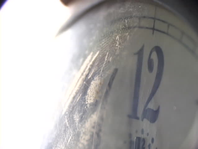 Time seems warped in this extreme close-up, as the minute hand on a vintage clock slowly moves towards twelve.