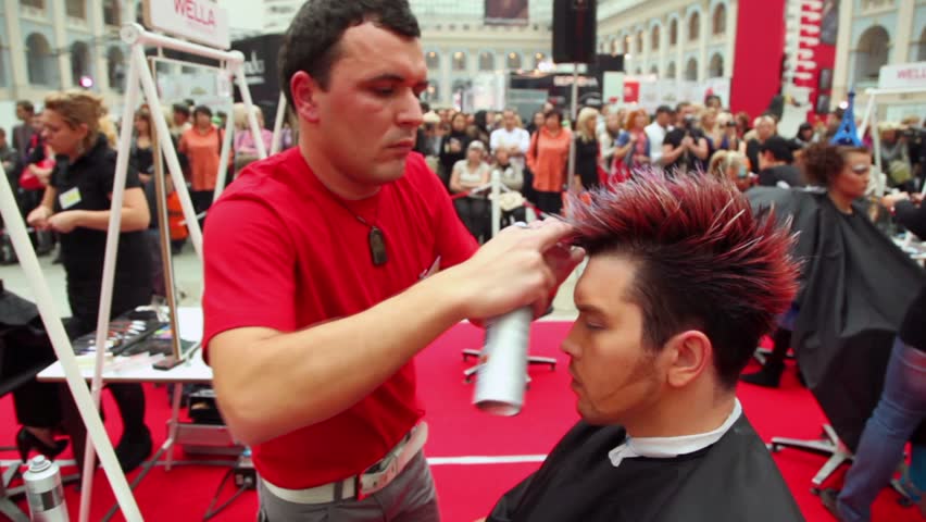MOSCOW - OCTOBER 2: Hairdresser makes hairstyle for young man at XVII International Festival World of Beauty 2010 in exhibition complex Gostiny Dvor, on October 2, 2010 in Moscow, Russia. 