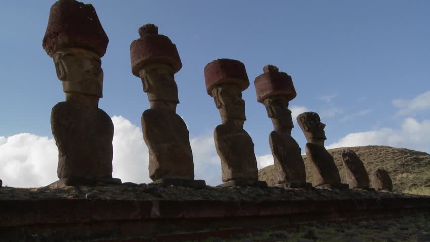 Easter Island statues stand in a long row.