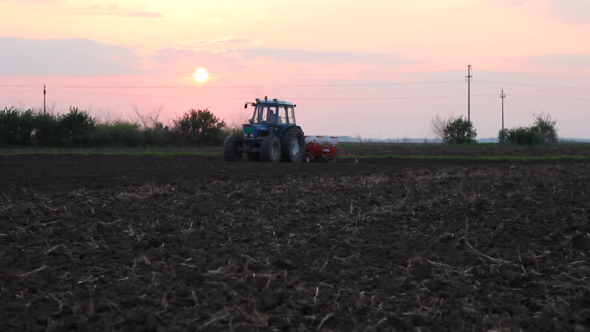 Seeder for sowing in a field at sunset