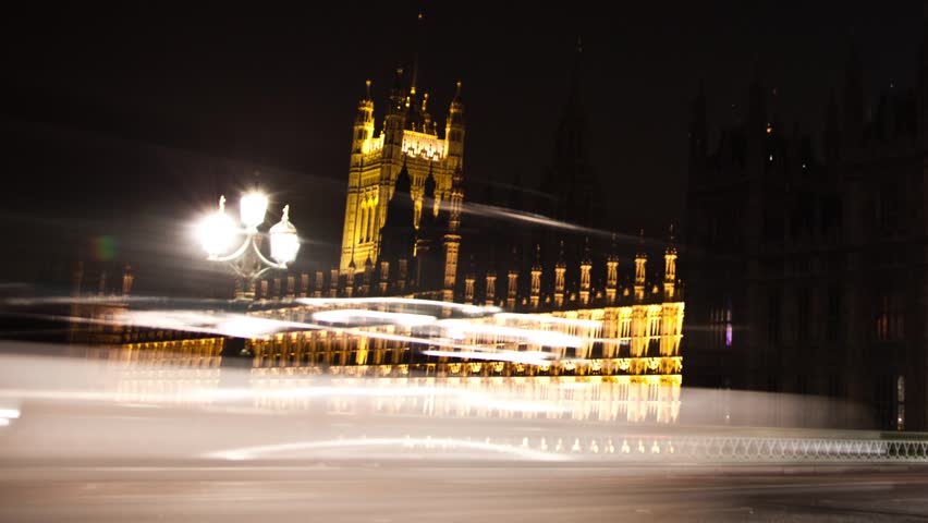 Night time lapse of Big Ben as traffic and people zip by on Westminster Bridge in London in July 2011.