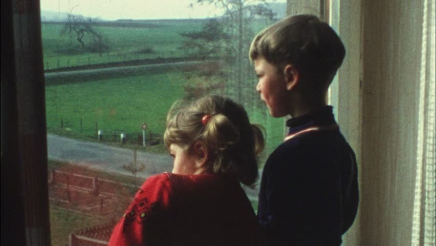 Children look out of window (vintage 8 mm amateur film)