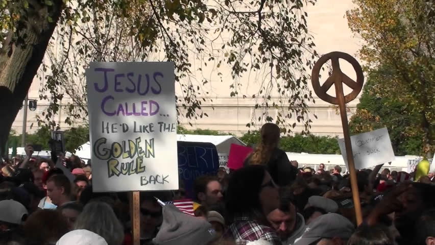 WASHINGTON, DC - CIRCA 2010: A protestor holds up a sign saying Jesus called and he'd like the golden rule back circa 2010 in Washington DC.