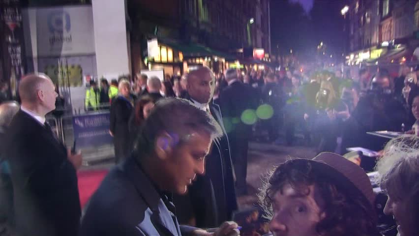 LONDON - OCT 19: George Clooney signs autographs at the gala screening of 'The Ides Of March' at The 55th BFI London Film Festival at Odeon West End on Oct 19, 2011 in London. 