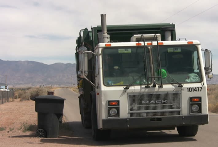Trash truck picking up a trash can and dumping it. Editorial use only due to visible logos. Converted to NTSC from HDV 1080i60.