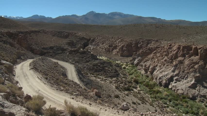 A truck on a winding dirt road in the altiplano above San Pedro de Atacama, Chile.