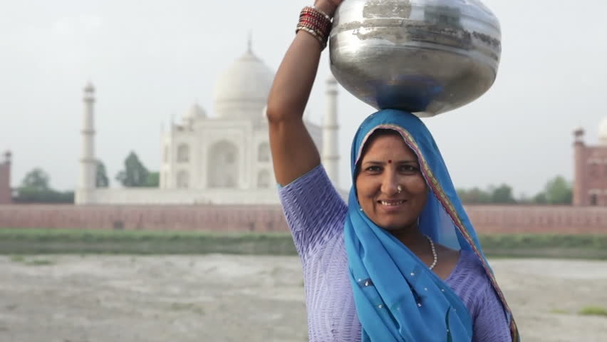 Indian Woman in traditional Sari in front of Taj MahalIndian Woman in traditional Sari in front of Taj Mahal, Agra, Uttar Pradesh, India