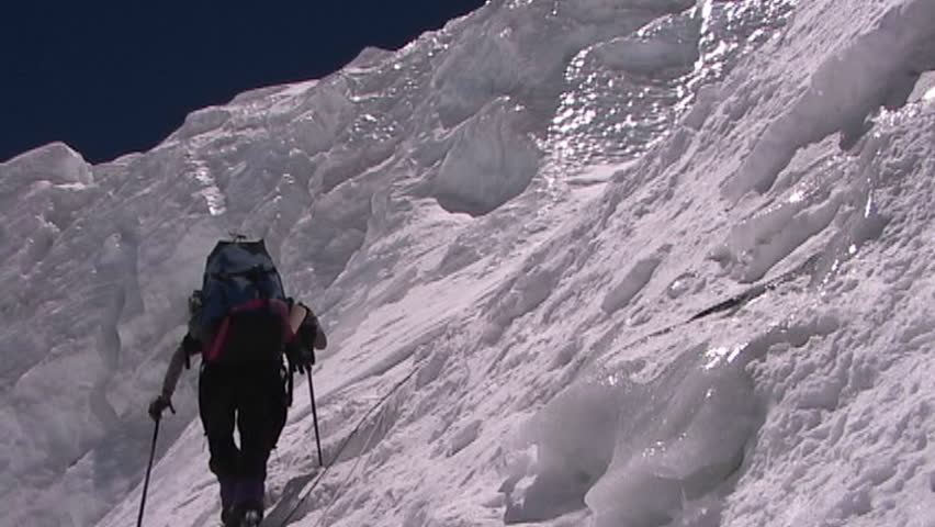 Climber ascends a vertical, icy slope circa 2005 in Tibet.