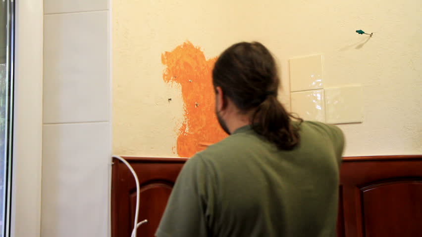 Master applies colored wax on ornamental plaster. 