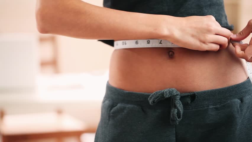 Woman measuring perfect sexy waist