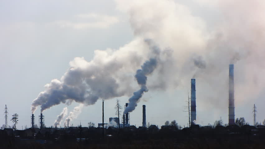 Smoke billows from factory, environmental pollution concept.