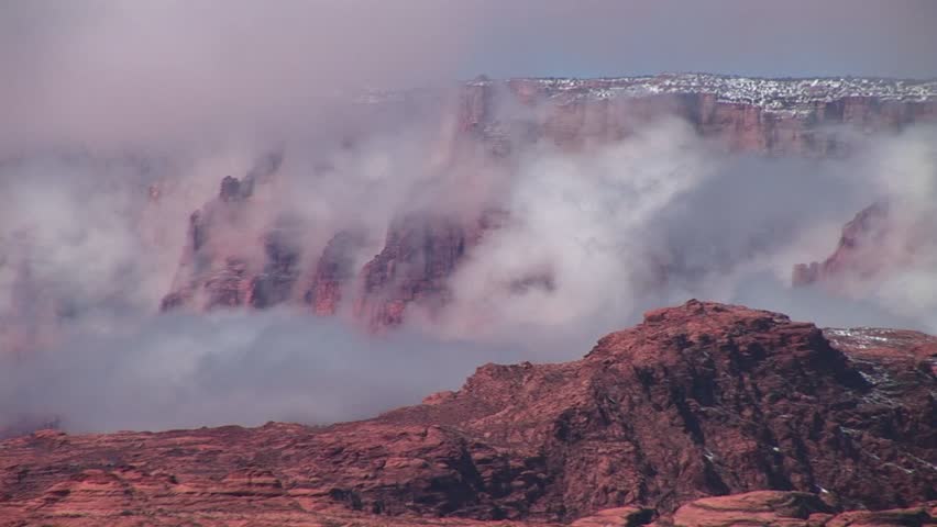 Medium-shot of fog slowly enveloping cliffs around Lake Powell, Arizona.
