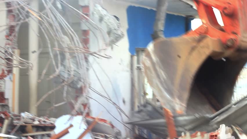 Building demolition, excavator and twisted rebars 