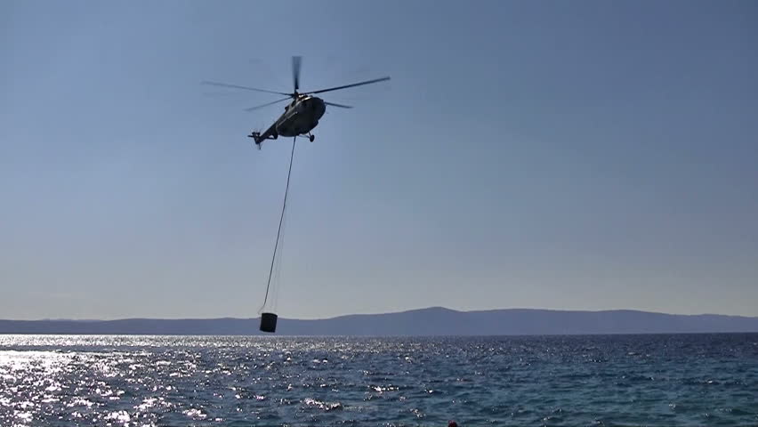 Fire fighter chopper in action at blue sea