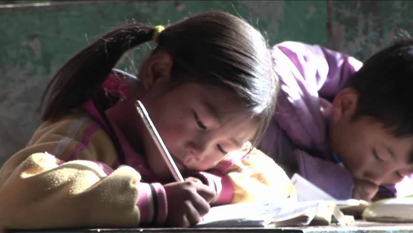 BEIJING, CHINA - CIRCA 2009: Children practice writing in a rural classroom circa 2009 in Beijing.