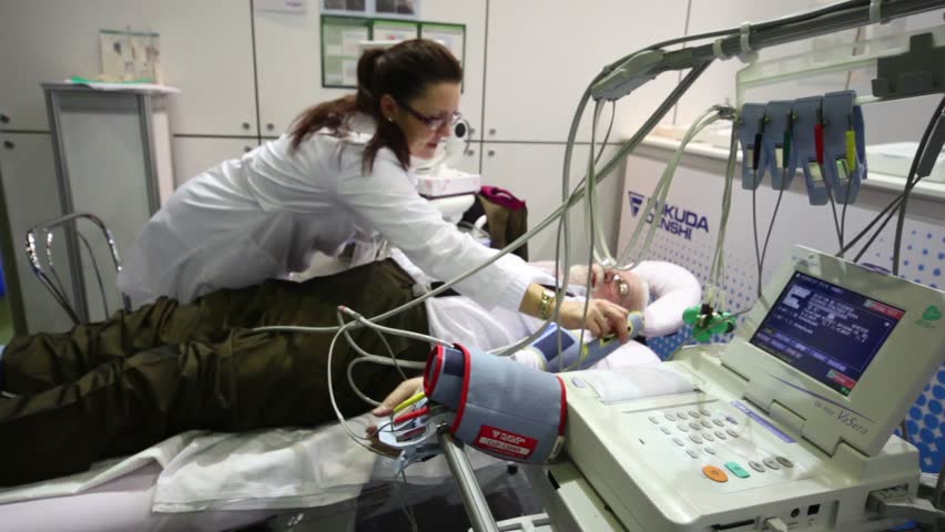 MOSCOW - DEC 8: Nurse caring for man at exhibition Zdravookhraneniye2010, 20th International Exhibition for Health Care, Medical Engineering and Pharmaceuticals, Dec 8, 2010, Moscow, Russia
