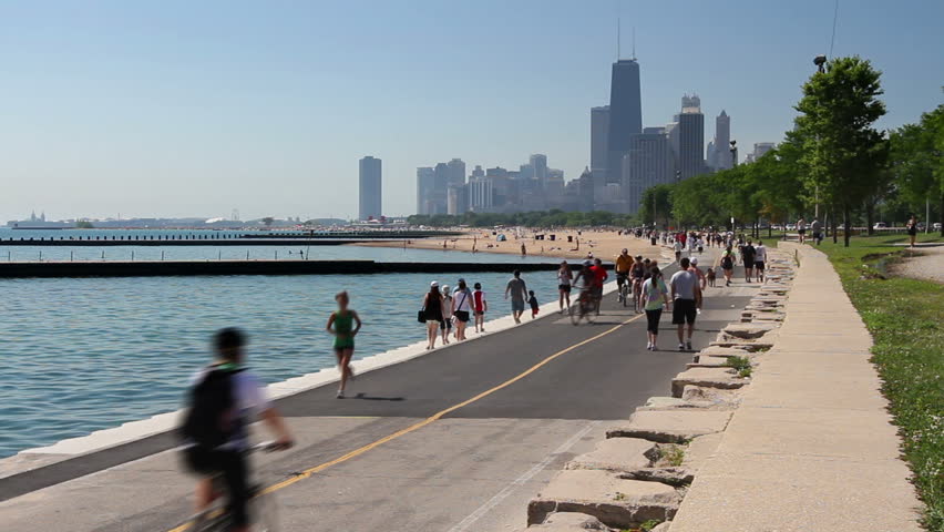Cyclists and runners enjoying a summer day on the Lakefront path along the Lake Michigan shoreline in Chicago. 