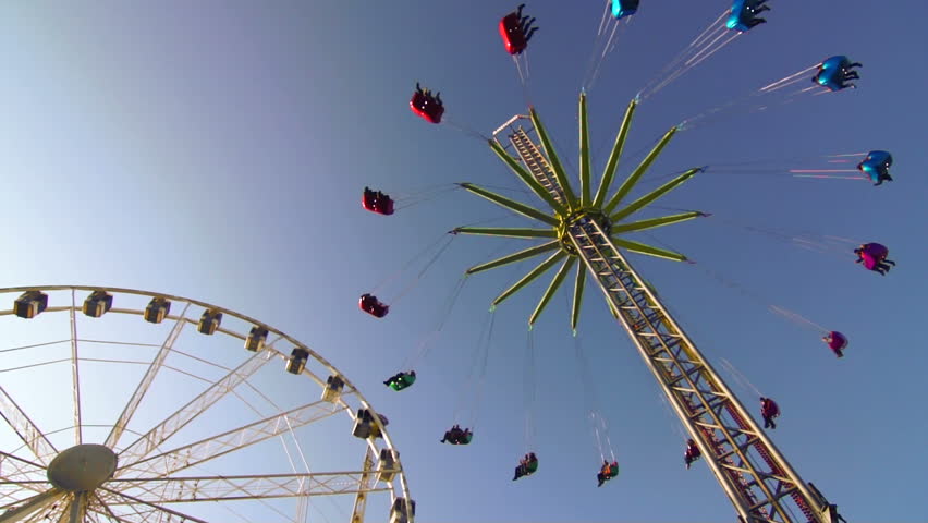 A clip in an amusement park as a go round finishes it's ride.