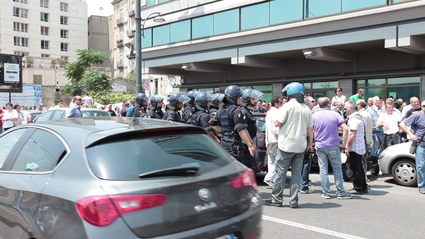 NAPLES, ITALY - MAY 26: Riot police watch protesters demonstrating on employment and financial problems in their country. May, 26 2011 in Naples, Italy. Unemployment and financial crisis growing.
