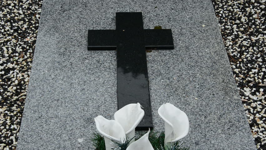 rain in the cemetery on the stone tomb