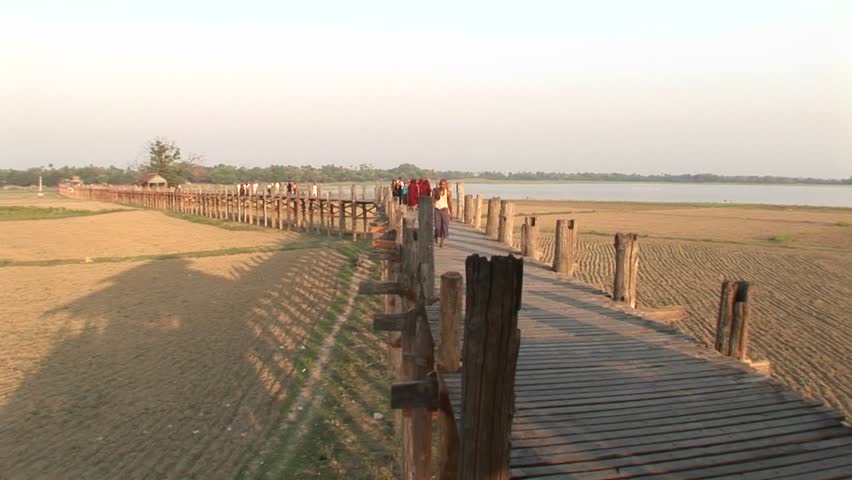 A villager wanders down a boardwalk.
