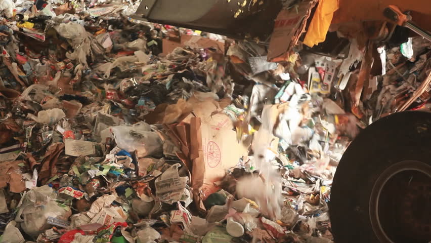 EASTERN U.S. - CIRCA 2008: A bulldozer hauls garbage