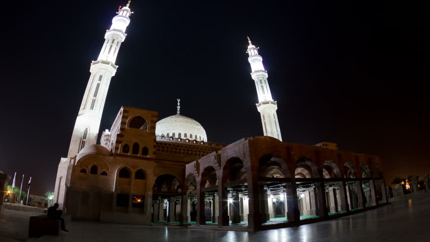 Mosque and two minarets at night, time lapse.