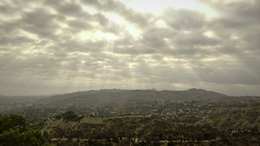 Cloud time lapse with sunbeams over the Hollywood hills