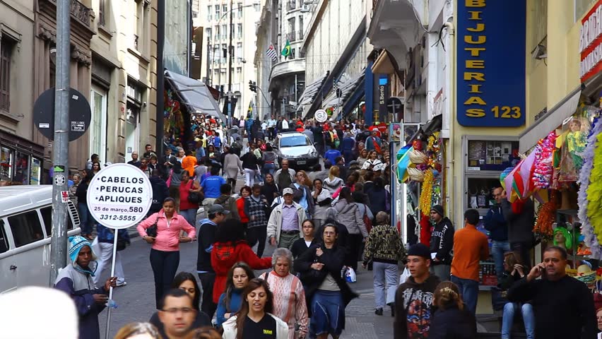 SAN PAULO, BRAZIL - CIRCA JUNE 2011: Pedestrians crowd a sloped commercial street circa June 2011 in San Paulo.