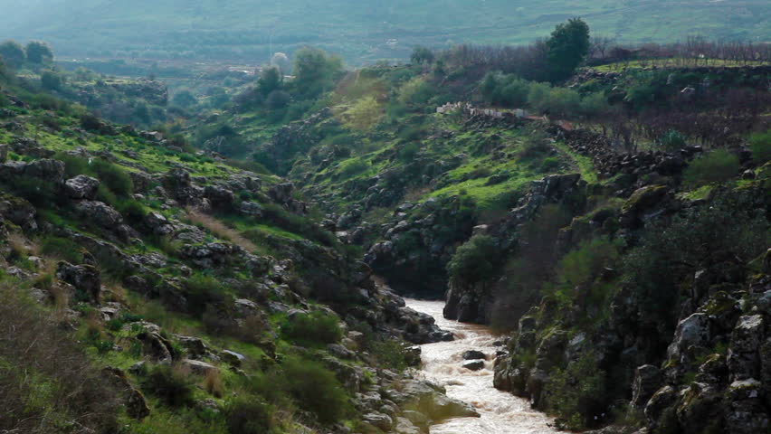 Wide shot of a winding river from the mountains of the Golan Heights in Israel.  