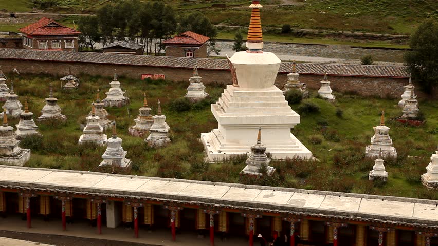 Wide shot of prayer wheels in Tagong, China