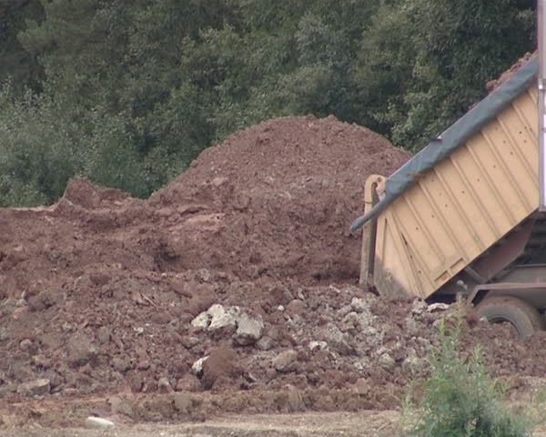 Heavy duty trucks. Truck dumps ground. Construction industry. 