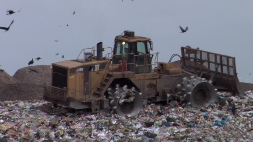 BOSTON, MA - CIRCA 2009: Bulldozer backs up over landfill