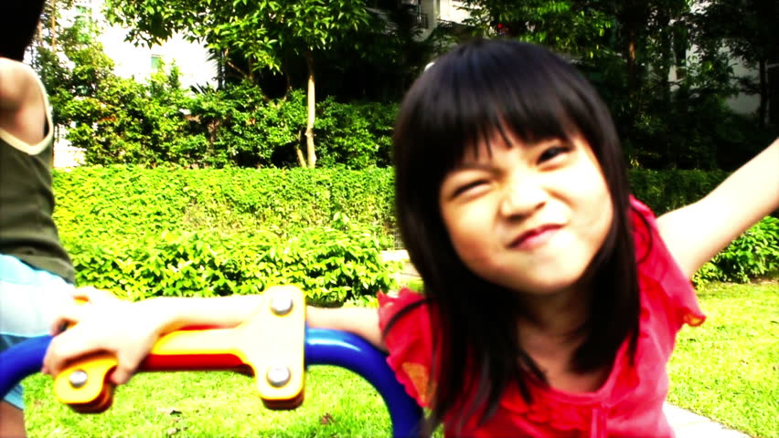 Asian girl playing at a playground