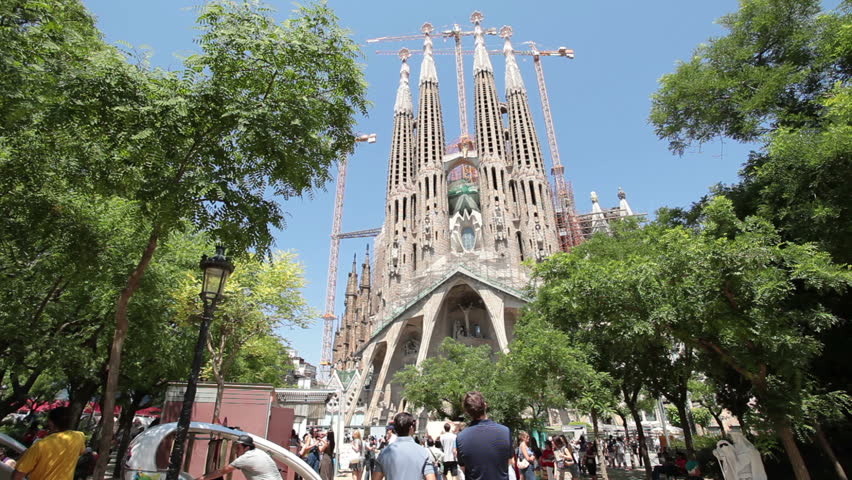 BARCELONA, SPAIN - MAY 22 2011 (Timelapse): Cathedral Sagrada Familia famous church and landmark with tourists and locals in city park in Barcelona, Spain on May 22, 2011. Fast motion timelapse.
