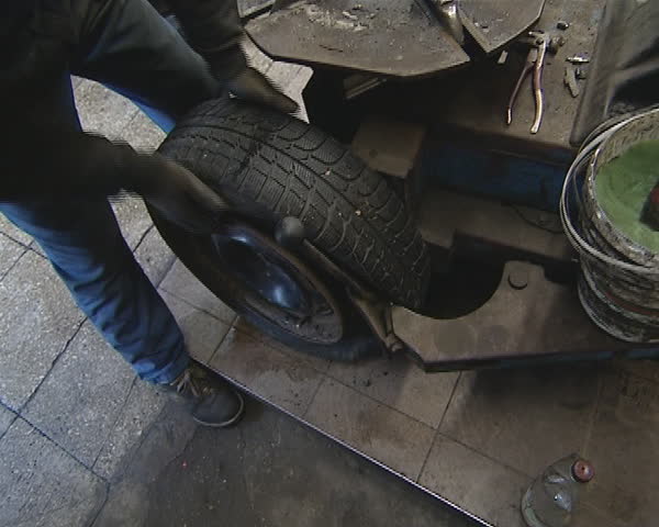 Dismantling of tire from rim. Automobile service station. Cars care industry. 