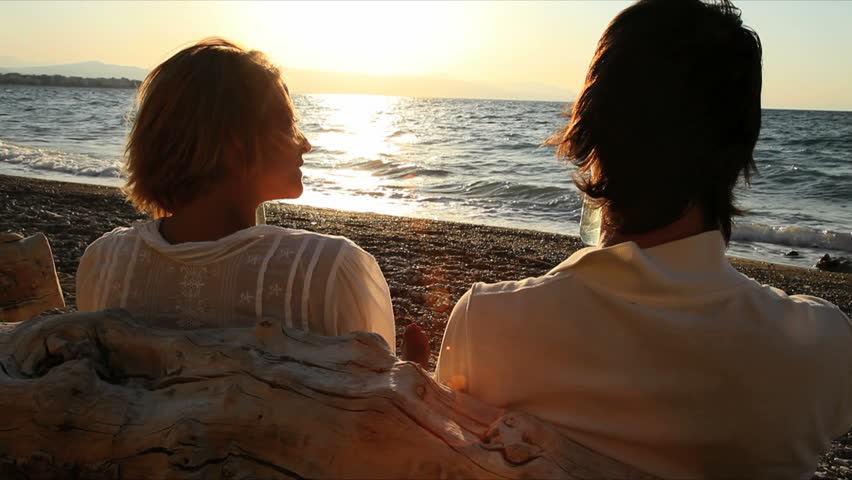 couple toasting with champagne in the sunset