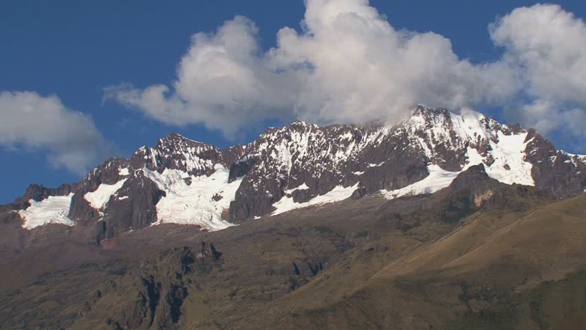 Zoom-out from snow-capped peak to WS of Andean valley
