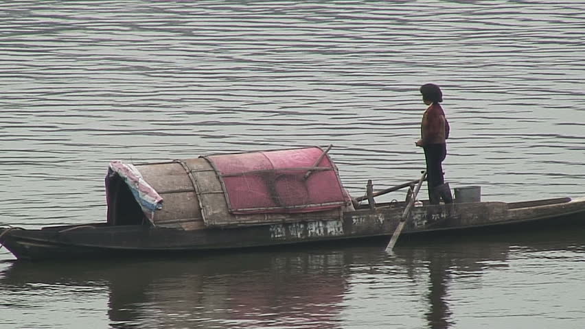 Woman Standing on Houseboat, China
