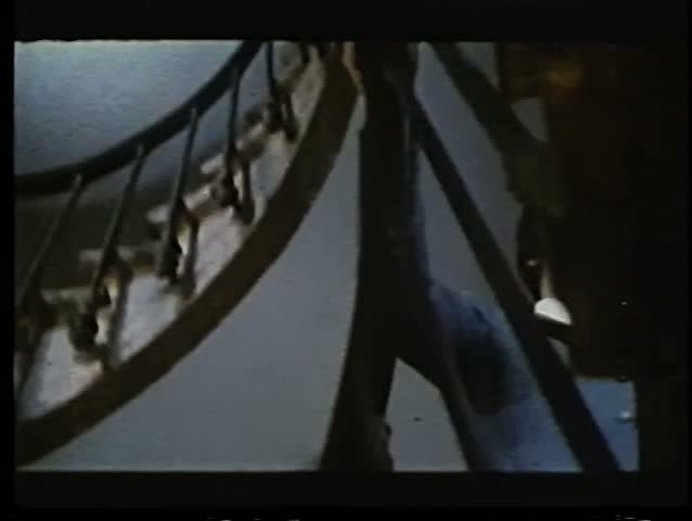 Low angle view of man walking up spiral staircase