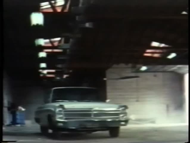White car driving through garage wall