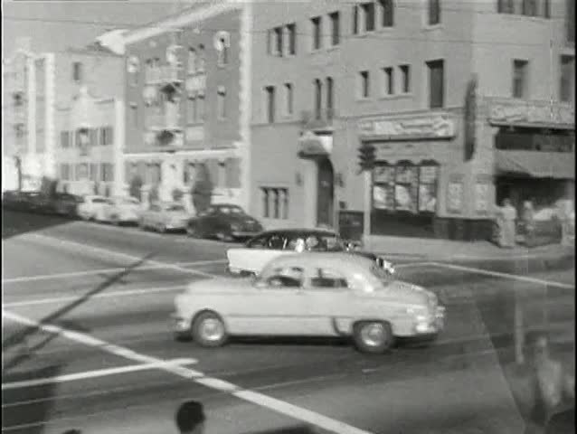 Policeman on motorcycle chasing car