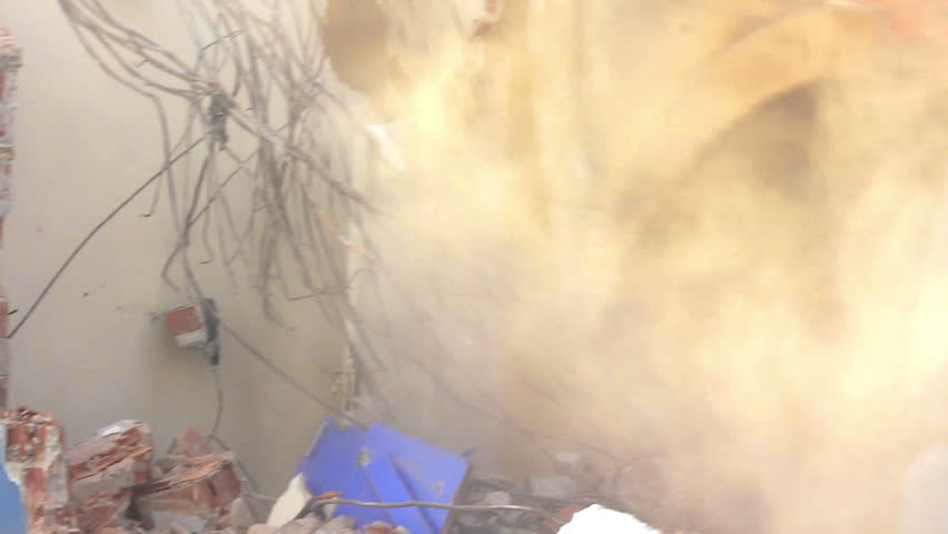 Building demolition, excavator and twisted rebars 